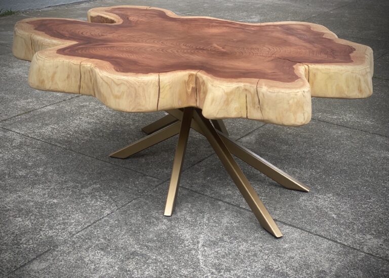 Handcrafted live edge table in Toronto made from a natural tree slice with bold grain patterns and golden metal legs.