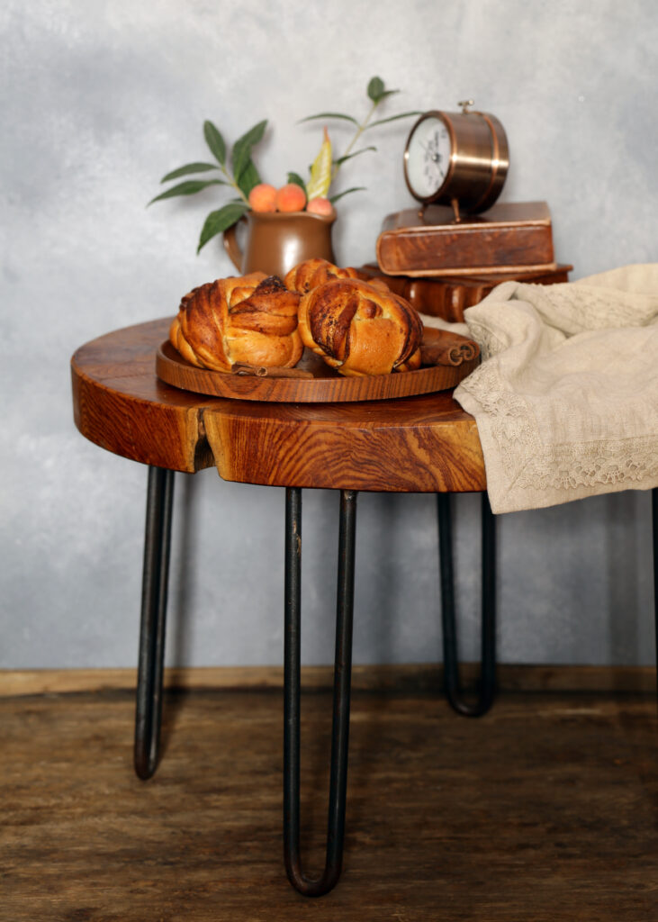 Handcrafted live edge table in Toronto with baked goods, vintage clock, and rustic décor accents.